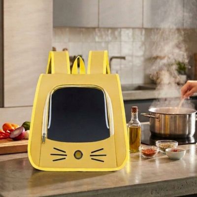 Sac à dos chat jaune posé sur un comptoir de cuisine en préparation

