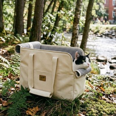 sac de transport pour chat beige posé herbe forêt nature
